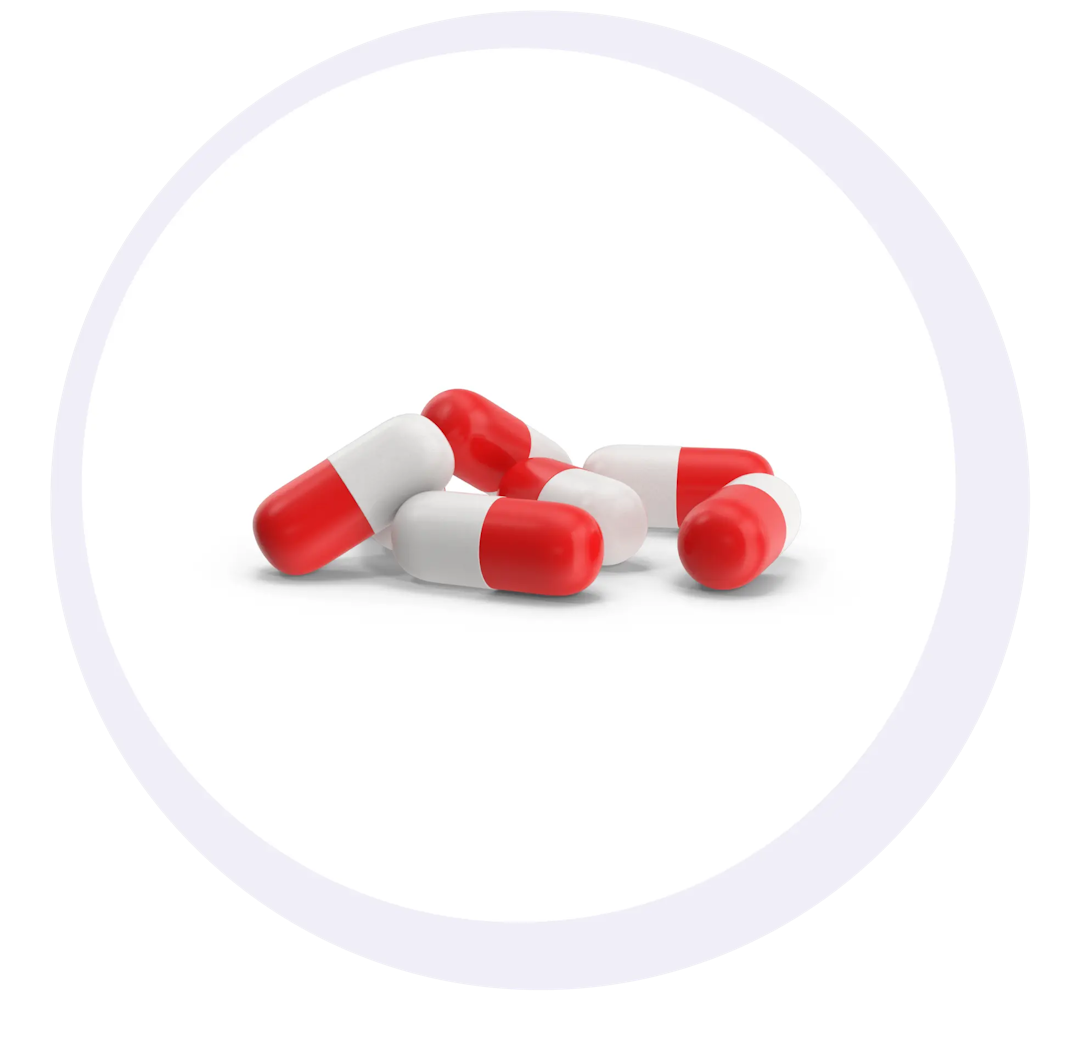 Red and white capsules lying on a plain white background within a circular frame, illustrating Medicine Service Eligibility.