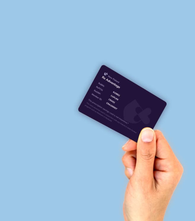 A hand holding a dark prescription savings card against a light blue background, representing the Rx Advantage Card for discounted medication pricing