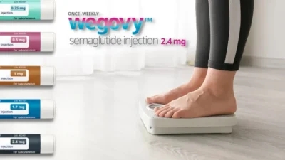 A woman is standing on a scale with a bottle of Wegovy, learning the correct steps for effective usage.