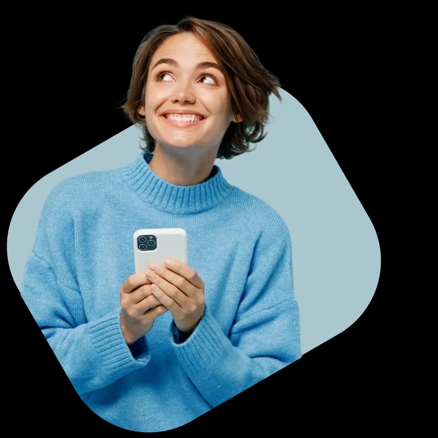 A smiling woman in a blue sweater holding a smartphone, exploring NowPatient's private health insurance quotes from FCA-regulated partners.